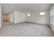 Bright and airy living room with grey carpet and access to hallway at 1011 Grassy Branch Dr, Indianapolis, IN 46239