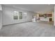 Spacious living room with grey carpet and kitchen view at 1011 Grassy Branch Dr, Indianapolis, IN 46239