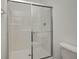 Modern shower with a sliding glass door and built-in shelving at 1011 Grassy Branch Dr, Indianapolis, IN 46239