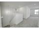 Upstairs hallway with carpeted flooring and a chandelier at 1011 Grassy Branch Dr, Indianapolis, IN 46239