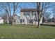 The backyard of the home features a well-maintained lawn and mature trees at 10229 Canal Way, Noblesville, IN 46060