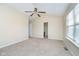 Spacious room with ceiling fan, neutral carpet, and natural light at 10229 Canal Way, Noblesville, IN 46060