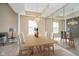 Elegant dining room featuring modern chandelier, large mirror, and a spacious table with seating for six at 10229 Canal Way, Noblesville, IN 46060
