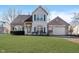 Charming two-story home with a brick facade, well-maintained lawn, and attached two-car garage at 10229 Canal Way, Noblesville, IN 46060