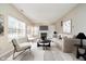 Bright living room with a fireplace, soft seating, and a large window at 10229 Canal Way, Noblesville, IN 46060