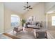 Cozy living room with vaulted ceilings, a large window, comfortable seating, and neutral tones at 10229 Canal Way, Noblesville, IN 46060