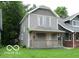 Two-story home featuring a covered front porch, and gray siding at 1053 W 35Th St, Indianapolis, IN 46208