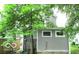 The back of the home, with a gray exterior and surrounded by greenery at 1053 W 35Th St, Indianapolis, IN 46208