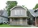 Charming two-story home with a covered front porch and gray siding at 1053 W 35Th St, Indianapolis, IN 46208