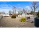 Backyard featuring a pea gravel yard, partial fence, small deck, and a storage shed at 1130 S Senate Ave, Indianapolis, IN 46225