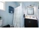 Well-lit bathroom showcasing a shower with a curtain and a vanity with cabinet storage at 1130 S Senate Ave, Indianapolis, IN 46225