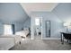 Bedroom with a connected bathroom featuring cool blue paint and gray carpet at 1130 S Senate Ave, Indianapolis, IN 46225