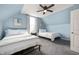 Cozy bedroom featuring two twin beds, a ceiling fan, and a window with natural light at 1130 S Senate Ave, Indianapolis, IN 46225