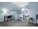 Cozy bedroom featuring a small desk, plush carpet, and an open doorway to another room at 1130 S Senate Ave, Indianapolis, IN 46225