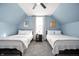 Charming bedroom with two twin beds, soft lighting, and decor, providing a cozy retreat at 1130 S Senate Ave, Indianapolis, IN 46225