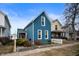 Inviting exterior of a two-story home with blue siding, red door, and neat landscaping at 1130 S Senate Ave, Indianapolis, IN 46225