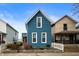 Charming blue two-story home featuring a well-manicured yard and classic architectural details at 1130 S Senate Ave, Indianapolis, IN 46225