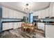Eat-in kitchen with white cabinets, stainless steel appliances, and modern lighting at 1130 S Senate Ave, Indianapolis, IN 46225