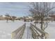 Wooden footbridge crossing a snow-covered path in a residential community at 121 W Wind Chime Cir, Greenwood, IN 46143