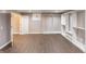 Spacious basement area with wood-look flooring and custom closet organizer system at 1284 Jesse Ct, Greenwood, IN 46143
