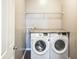 Convenient laundry area with side-by-side washer and dryer and built-in shelf at 1284 Jesse Ct, Greenwood, IN 46143
