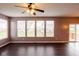 Light-filled living room showcasing hardwood floors, a large window, and sliding door access to the deck at 1284 Jesse Ct, Greenwood, IN 46143