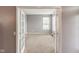 Bright living room featuring neutral walls and plush carpeting viewed through french doors at 1284 Jesse Ct, Greenwood, IN 46143