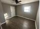 Bright bedroom featuring wood-look floors and ceiling fan at 129 E Stop 13 Rd, Indianapolis, IN 46227