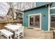 Wooden deck with a white table and chairs, blue siding, and French doors at 1468 Alabama St, Indianapolis, IN 46202