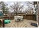 Wooden deck with a white table and chairs, surrounded by trees at 1468 Alabama St, Indianapolis, IN 46202