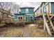 Backyard shot features the house, a wood deck, and a treehouse with a slide and swings at 1468 Alabama St, Indianapolis, IN 46202