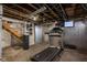 Spacious basement featuring exercise equipment, a finished wall, and stairs at 1468 Alabama St, Indianapolis, IN 46202