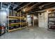 Unfinished basement with storage shelving, exposed beams, and a concrete floor at 1468 Alabama St, Indianapolis, IN 46202