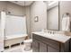Bathroom features a classic clawfoot tub, modern vanity, and gray cabinets at 1468 Alabama St, Indianapolis, IN 46202