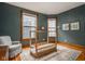Cozy bedroom featuring a unique canopy bed frame, hardwood floors, and natural light from two large windows at 1468 Alabama St, Indianapolis, IN 46202