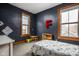 Bedroom with navy walls, natural light, toy furniture, and a bed with a colorful truck pattern at 1468 Alabama St, Indianapolis, IN 46202