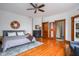 Spacious bedroom with hardwood floors, decorative fireplace, and ensuite bathroom access at 1468 Alabama St, Indianapolis, IN 46202