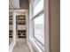 Organized walk-in closet with built-in shelving and a large window for natural light at 1468 Alabama St, Indianapolis, IN 46202
