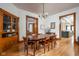 Bright dining room with hardwood floors, built-in cabinet, and decorative doorway trim at 1468 Alabama St, Indianapolis, IN 46202