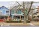 Charming two-story home with teal siding and inviting front porch, framed by a mature tree at 1468 Alabama St, Indianapolis, IN 46202