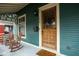 Inviting front porch featuring a wooden door and classic rocking chairs at 1468 Alabama St, Indianapolis, IN 46202