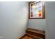 Stairway landing with stained glass window and a built-in wooden storage bench at 1468 Alabama St, Indianapolis, IN 46202