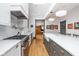 A modern kitchen is equipped with stainless steel appliances, a white tile backsplash, and hardwood floors at 1468 Alabama St, Indianapolis, IN 46202