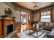 Elegant living room featuring a decorative fireplace, detailed ceiling, and hardwood floors at 1468 Alabama St, Indianapolis, IN 46202