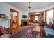 Cozy living room featuring hardwood floors, fireplace, and intricate wood trim details at 1468 Alabama St, Indianapolis, IN 46202