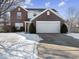 Brick two-story house with a large driveway, snow-covered lawn at 173 Davis Dr, Whiteland, IN 46184