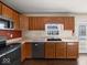 Kitchen boasts wood cabinets, stainless steel appliances, and a window above the sink at 173 Davis Dr, Whiteland, IN 46184