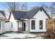 Charming white house with black accents and a snow-covered front yard at 1730 Union St, Columbus, IN 47201