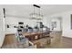 Modern kitchen with white cabinets and a rustic wood dining table at 19807 Patcham Rd, Westfield, IN 46074