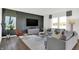 Spacious living room with gray sectional sofa and accent chair, wood-look floors at 19807 Patcham Rd, Westfield, IN 46074